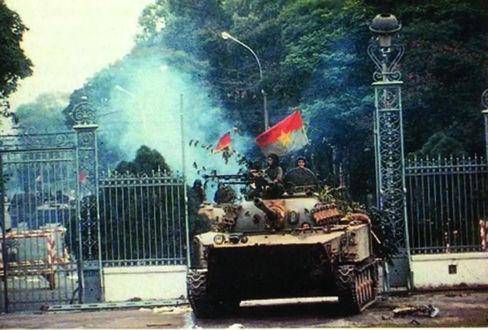 A North Vietnamese tank crashing through the gates of the Independence Palace in Saigon on April 30, 1975, symbolizing the fall of Saigon and the reunification of Vietnam.
