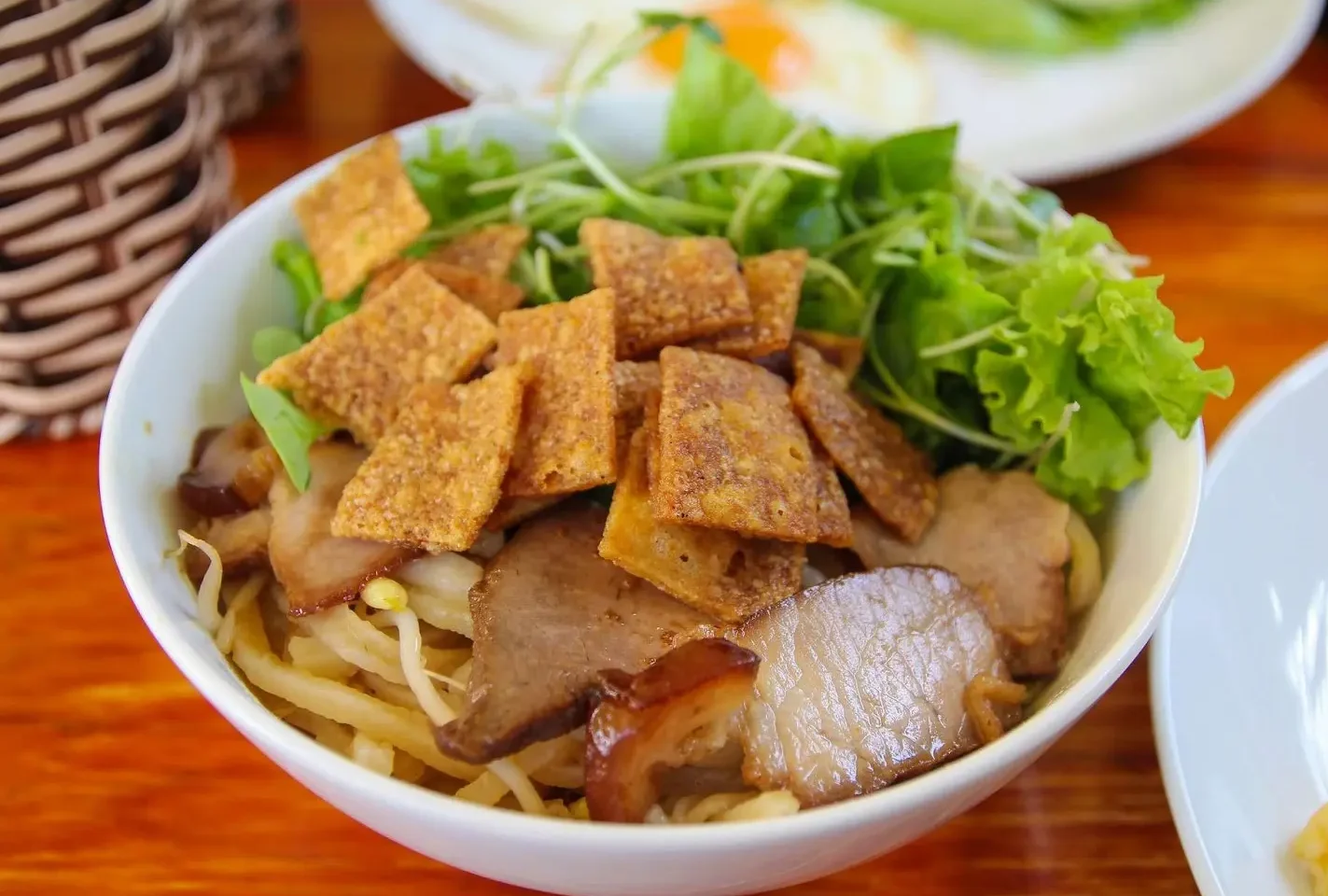 Appetizing bowl of traditional Cao Lau noodles, a local dish from Hoi An Vietnam.