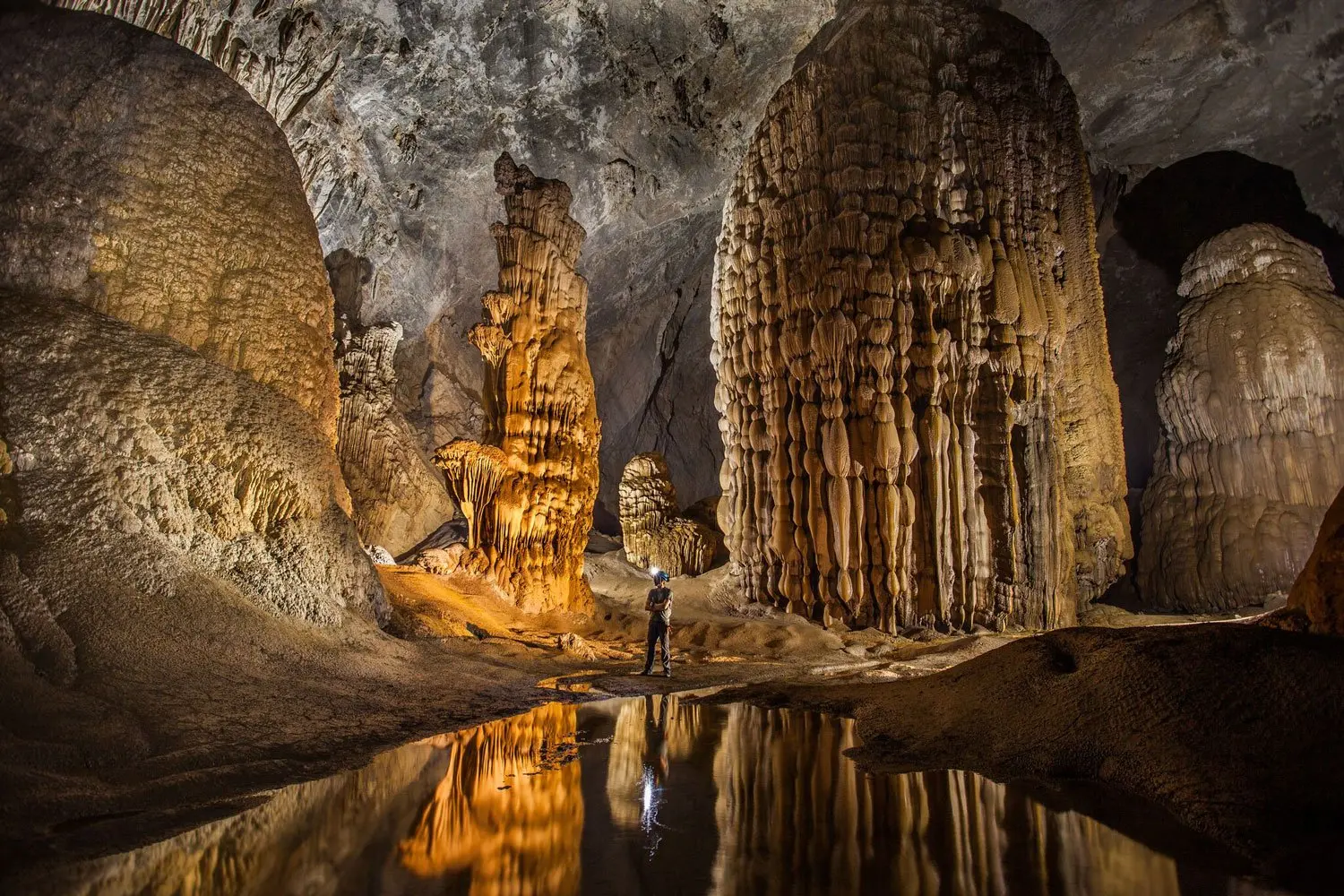 Giant stalagmite formations showcasing the karst geology inside Vietnam Hang Son Doong Cave, Quang Binh.