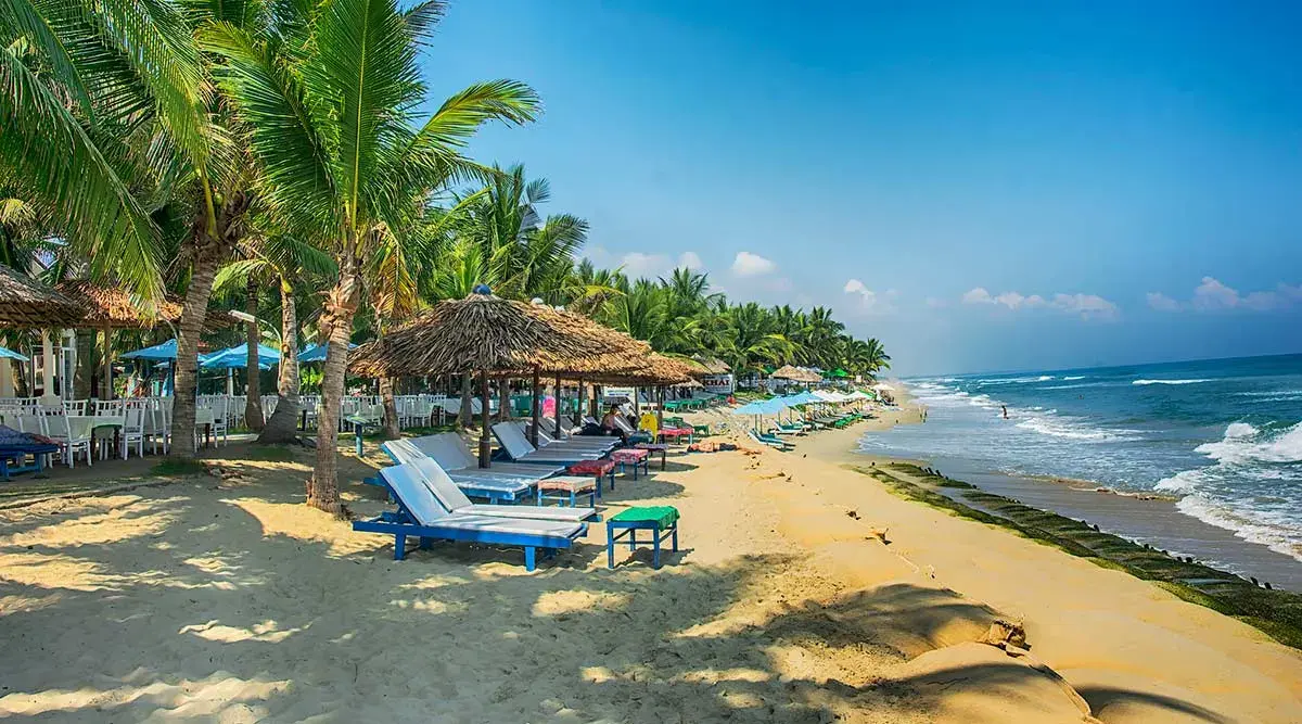Relaxing view of the sandy shore and turquoise sea at An Bang Beach, Hoi An Vietnam.