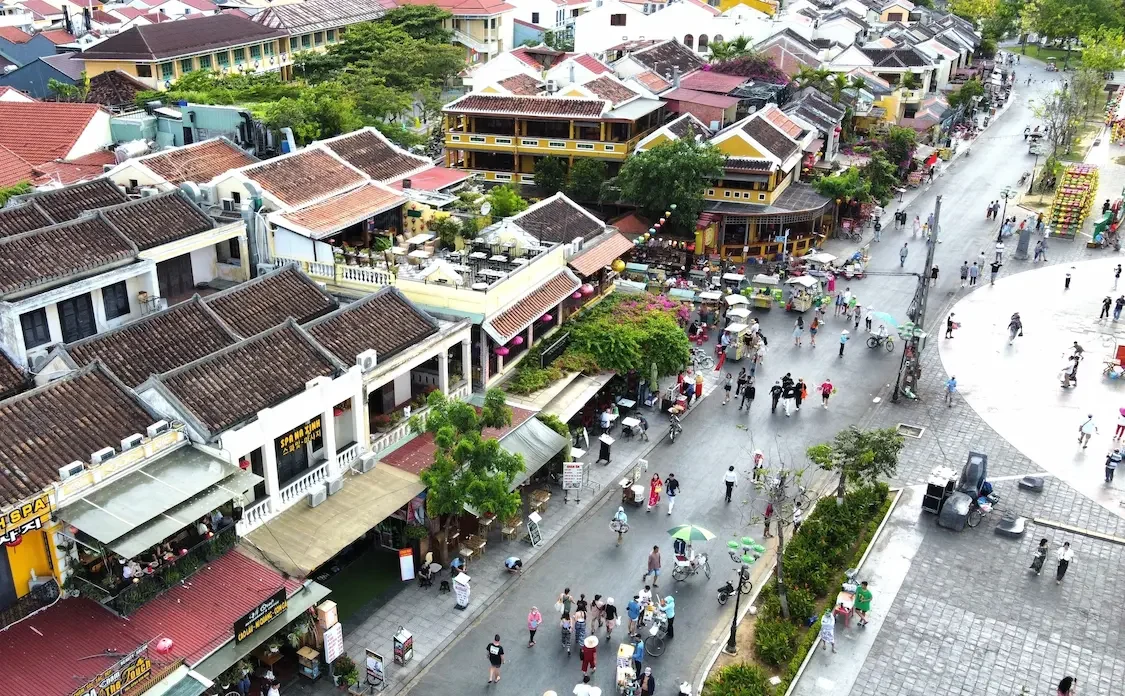 Sunlit street with iconic yellow walls and traditional architecture in Hoi An Ancient Town, Hoi An Vietnam.