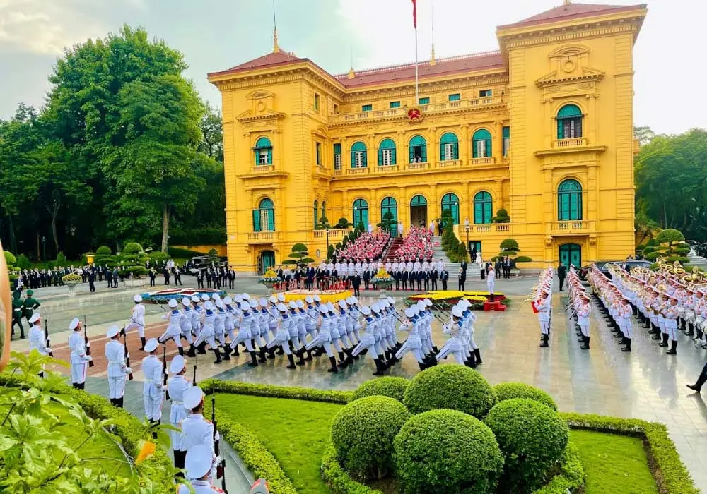 Presidential Palace facade in Hanoi, confirming the answer to 'what is capital of vietnam', under a blue sky.