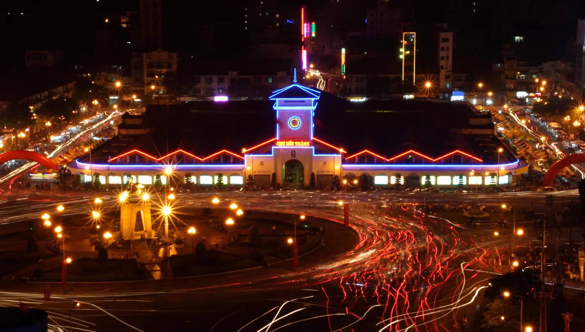 Bustling street-level view of the iconic Ben Thanh Market entrance in Ho Chi Minh City Vietnam.