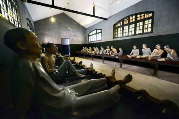 Dimly lit stone corridor of French colonial prison Hanoi Vietnam Hoa Lo