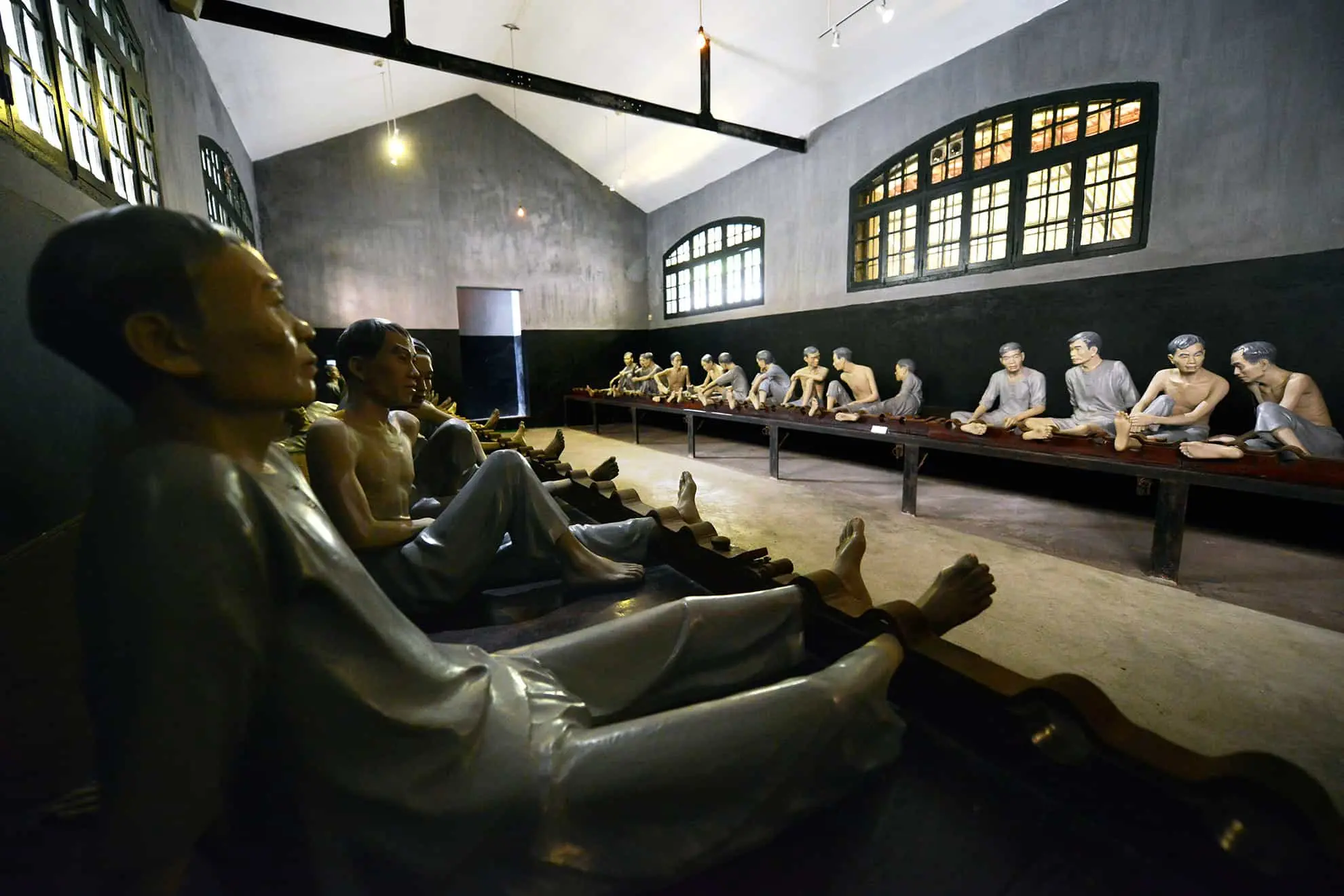 Dimly lit stone corridor of French colonial prison Hanoi Vietnam Hoa Lo