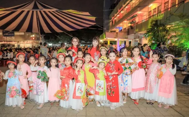 Multi-generational Vietnamese family celebrating Mid-Autumn Festival festive food.