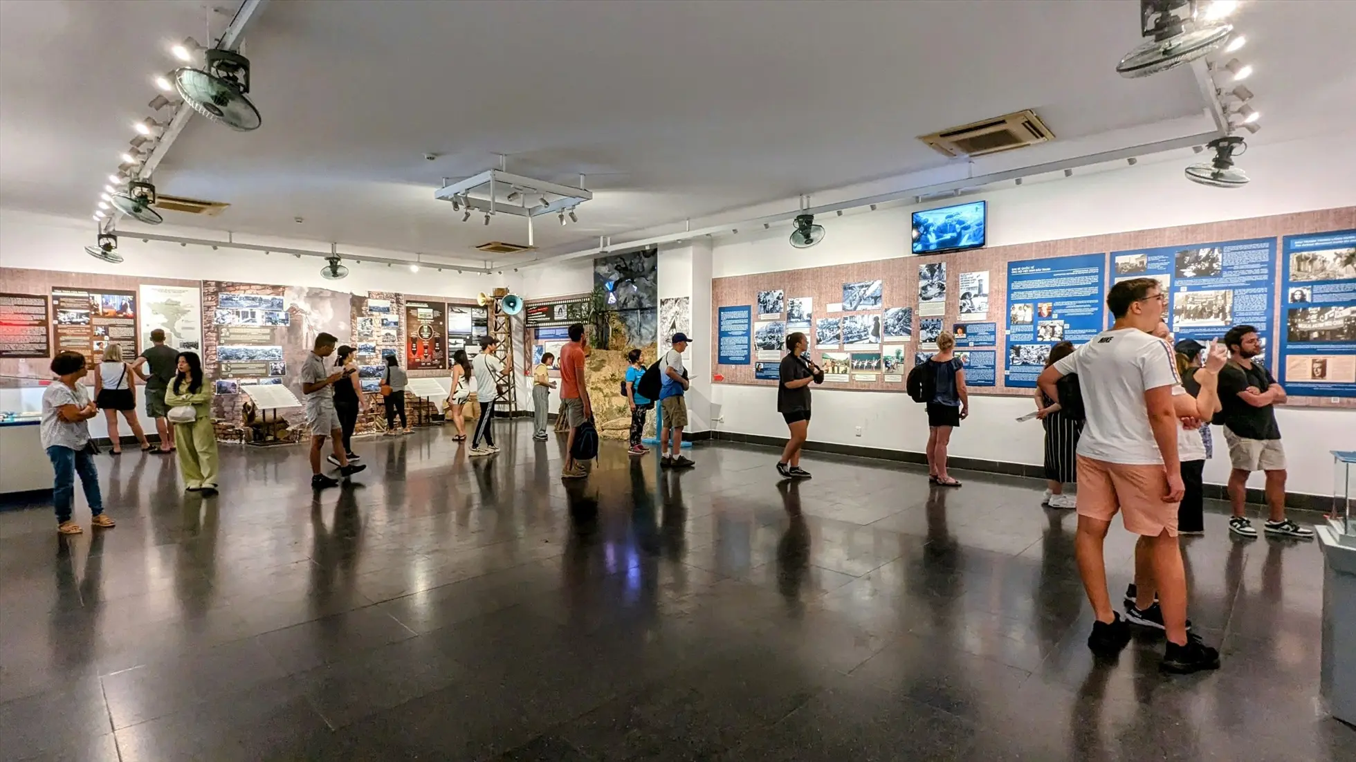 Visitors observing historical artifacts in an exhibition hall at the War Remnants Museum Vietnam1