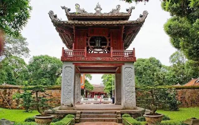 The iconic red Khue Van Cac pavilion at the Temple of Literature, Hanoi, surrounded by gardens