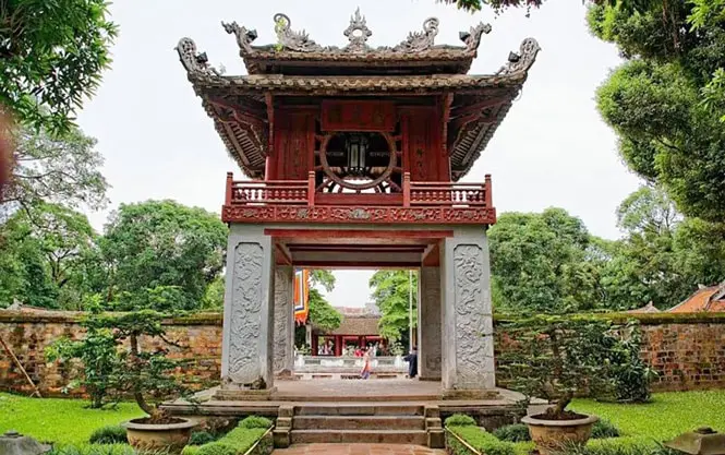 The iconic red Khue Van Cac pavilion at the Temple of Literature, Hanoi, surrounded by gardens